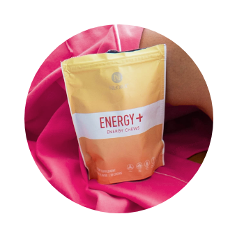 Image of Neora Energy+ Wellness Chews sitting on a pink blanket.
